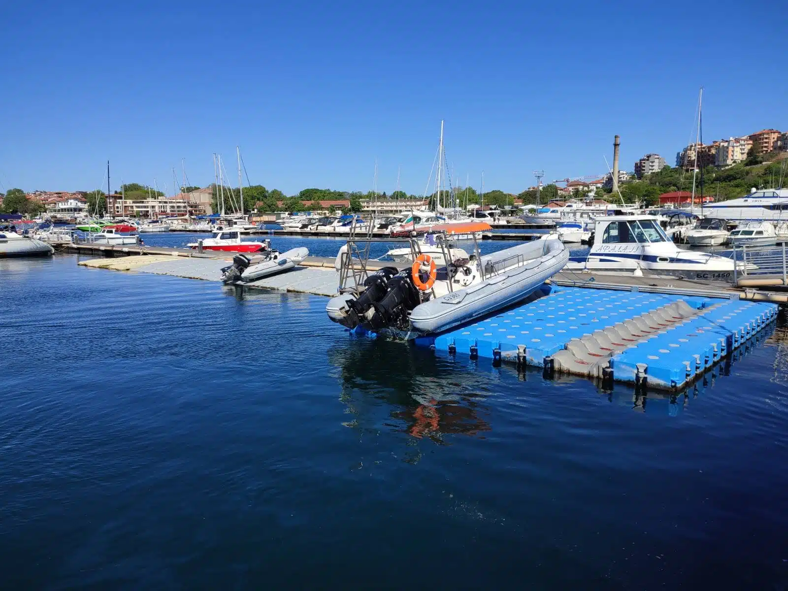 Inflatable boat moored on floating marina dock