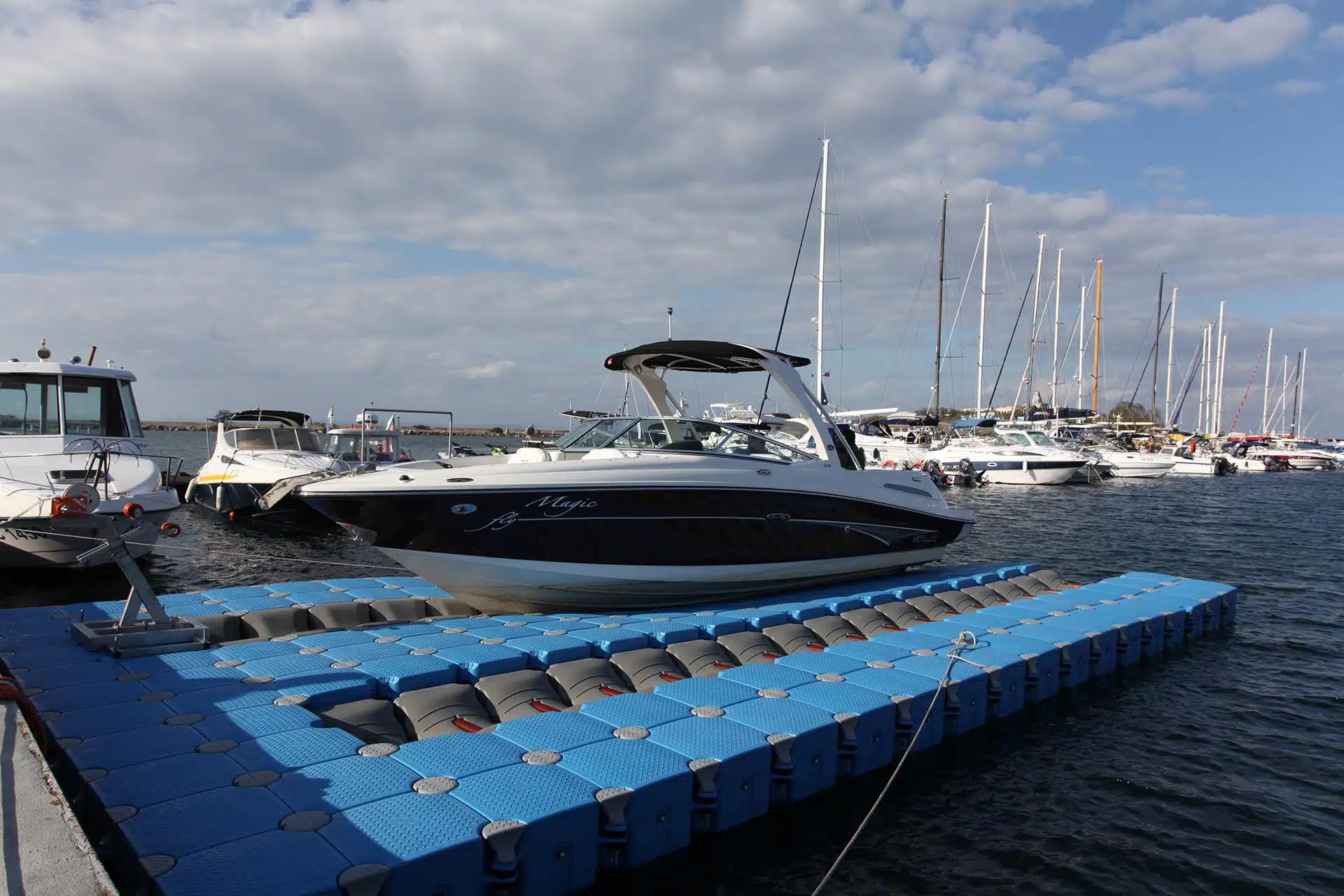 Motorboat moored at floating dock in marina