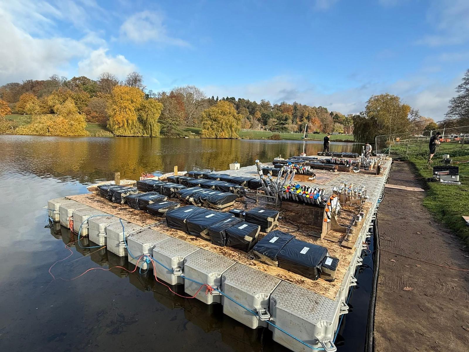 Floating fireworks platform on autumn lake